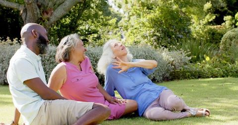 Senior Friends Laughing Outdoors on Sunny Day in Park