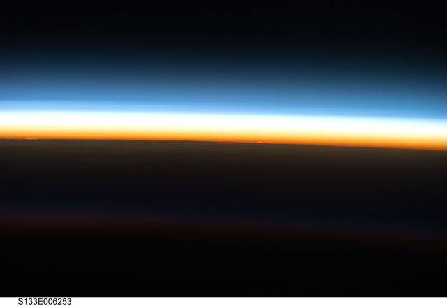 Visual showcasing vibrant, multi-layered horizon as seen from Space Shuttle Discovery. Ideal for materials on space exploration, astronomy, atmosphere studies, or NASA missions. Perfect for educational content, sci-fi backdrops, and inspirational posters.