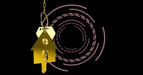 Golden house keychain hanging on keyring with magenta concentric rings on black backdrop