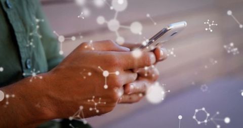 Man Texting on Mobile Phone with Floating Molecular Structures