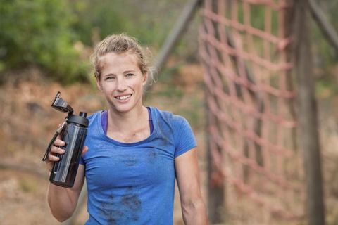 Female Athlete with Water Bottle at Outdoor Challenge Course