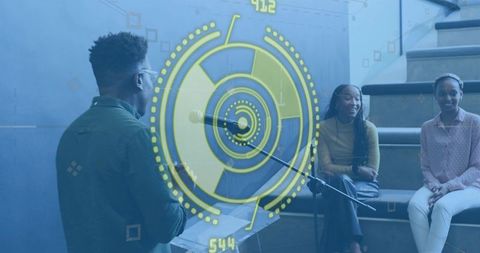 Young presenter addressing small audience with futuristic HUD overlay, modern learning talk