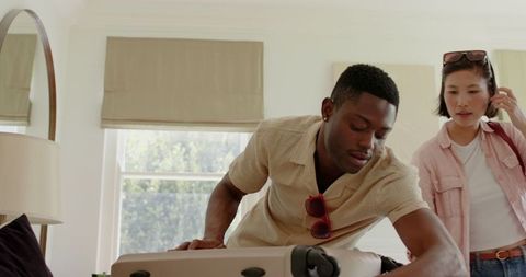 Couple packing suitcase at home for special occasion