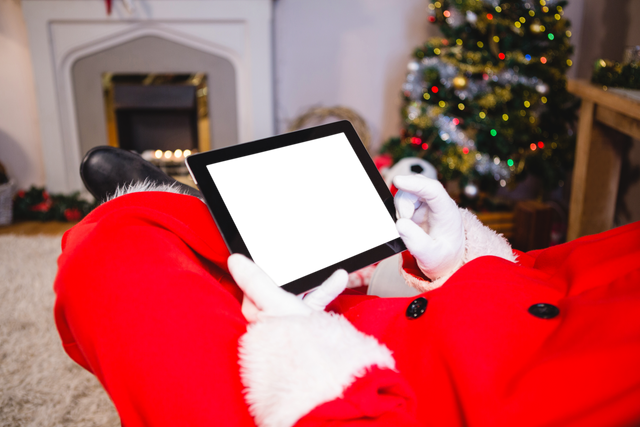 Santa Claus Sitting and Using Digital Tablet in Cozy Christmas Setting - Download Free Stock Videos Pikwizard.com