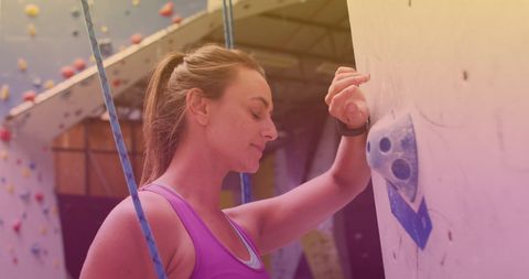 Fit Woman Poised for Indoor Rock Climbing Exercise Adventure