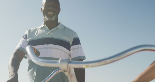 Smiling Senior Man Riding Bicycle on a Sunny Day - Download Free Stock Images Pikwizard.com