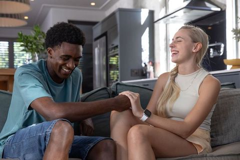 Diverse Couple in Modern Living Room Enjoying Time Together