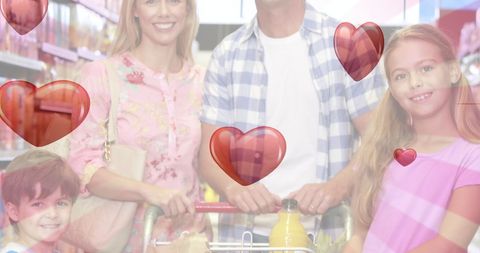 Happy family shopping together surrounded by digital hearts