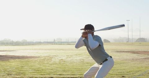 Baseball Batter Practicing Morning Swing on Dewy Field for Training and Focus
