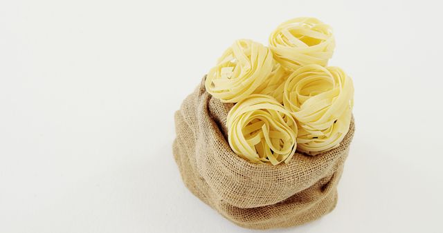 Nests of Tagliatelle Pasta in Burlap Bag Against White Background - Download Free Stock Images Pikwizard.com