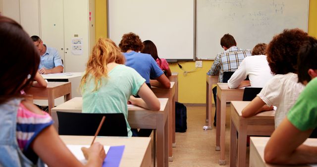 Students Taking Exam in Classroom Setting with Whiteboard - Download Free Stock Images Pikwizard.com