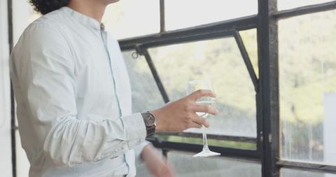 Business Casual Man Enjoying Wine in Modern Office