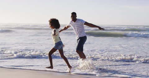 Happy Couple Enjoying Beach with Playful Energy