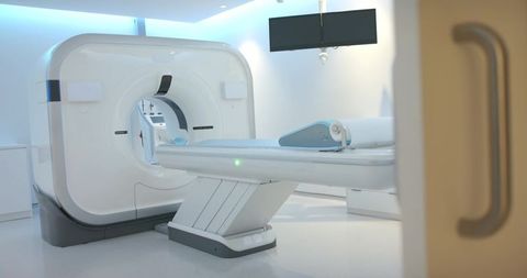 Minimalist ct scanner room with motorized patient table and blue ambient lighting