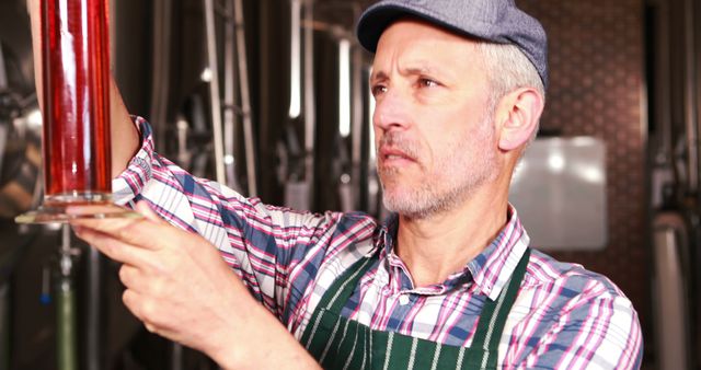 Experienced Brewery Worker Inspecting Fresh Beer in Brewery - Download Free Stock Images Pikwizard.com