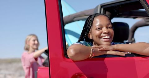 Friends Enjoying Scenic Road Trip in Convertible on Sunny Day
