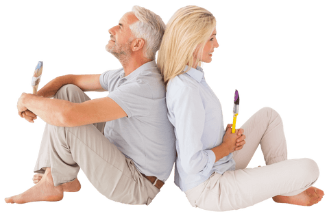 Happy Mature Couple Sitting Back to Back Holding Paint Brushes Transparent