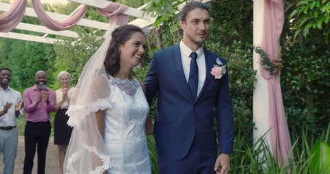 Joyful outdoor wedding ceremony with smiling bride and groom