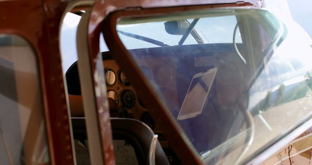 Inside view of a vintage aircraft cockpit, showing aged control panels and instruments, with copy space. The image evokes a sense of nostalgia and highlights the evolution of aviation technology.