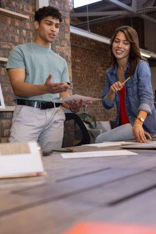 Diverse Colleagues Collaborating in Modern Loft Office