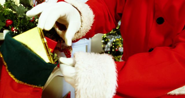Santa Claus Filling Christmas Stocking with Gift - Download Free Stock Images Pikwizard.com
