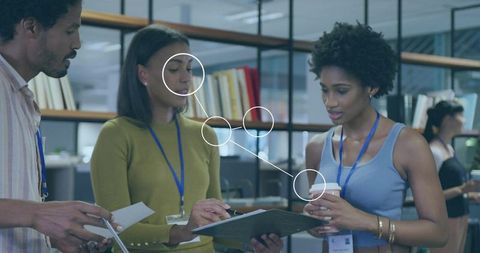 Collaborative team review in modern open-plan office