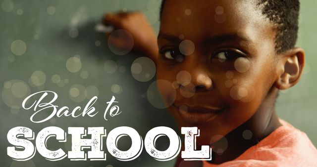 Smiling Black Child Writing on Chalkboard for Back to School - Download Free Stock Images Pikwizard.com