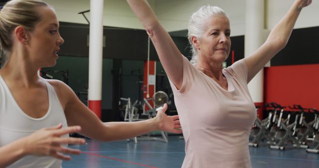 Senior Woman Practicing Yoga with Instructor in Fitness Center - Download Free Stock Images Pikwizard.com