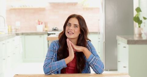 Woman Wearing Plaid Shirt Communicating in Cozy Kitchen