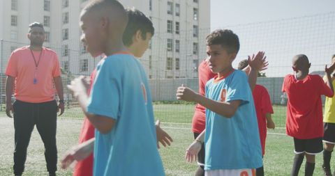 Youth Soccer Teams Shaking Hands on Sunny Day