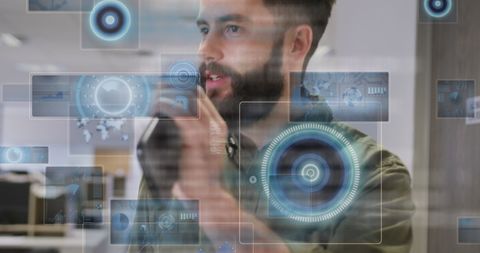 Businessman engaging with futuristic digital holograms in office