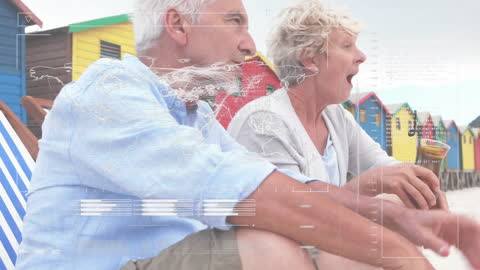 Senior Couple Enjoying Beach with Animated Financial Data Overlay