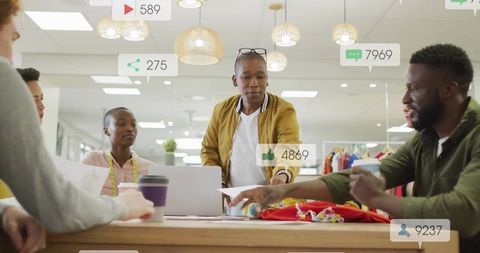 Dynamic Team Collaborating on Creative Fashion Designs in Modern Office