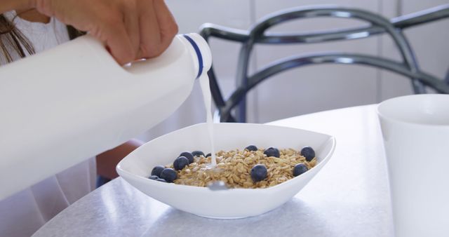 Close-up Pouring Milk Over Blueberry Cereal Breakfast - Download Free Stock Images Pikwizard.com