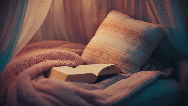 Cozy Nook with Open Book and Pillow Surrounded by Curtains