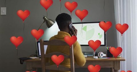 Professional Woman Working in Comfortable Home Office Surrounded by Heart Balloons