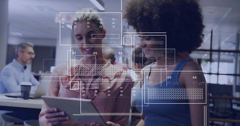 Female Colleagues Analyzing Data Code in Open Office