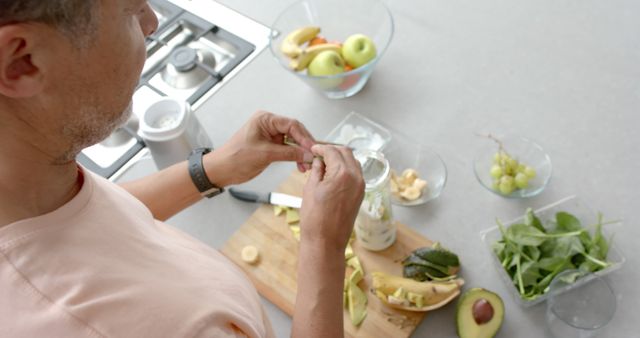 Man Preparing Healthy Smoothie with Fresh Fruits and Vegetables in Kitchen - Download Free Stock Images Pikwizard.com