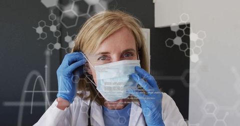 Medical Doctor Adjusting Mask in Clinical Setting with Molecular Graphics