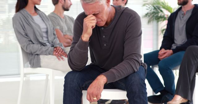 Man experiencing emotional stress during group therapy session - Download Free Stock Images Pikwizard.com
