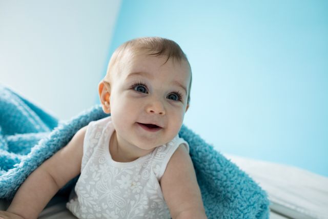 Cute baby girl smiling on bed - Download Free Stock Photos Pikwizard.com