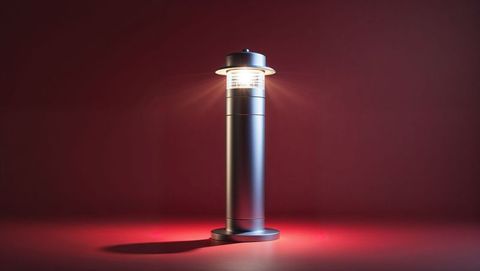 Modern metallic lamp casting ambient light on red background