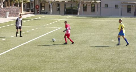 Young Soccer Players Competing on Green Field in Intense Match