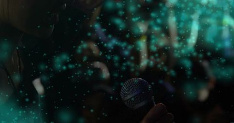 Chinese female singer holding microphone on dim stage with teal bokeh, intimate vibe