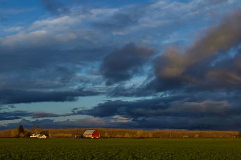 Dramatic Evening Sky Over Peaceful Rural Farmhouse