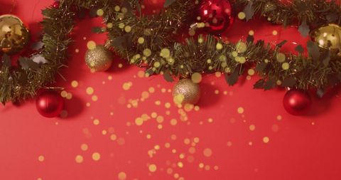 Golden Christmas Baubles and Garland on Red Background with Falling Glitter - Download Free Stock Images Pikwizard.com