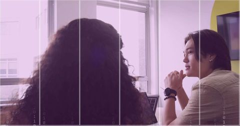 Women Colleagues Collaborating in Modern Meeting Room