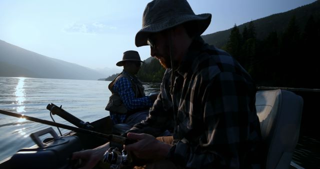Men Fishing Early Morning on Lake with Mountains in Background - Download Free Stock Images Pikwizard.com