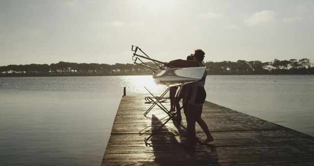 Rowers Preparing Boat on Wooden Dock by Calm Lake - Download Free Stock Images Pikwizard.com