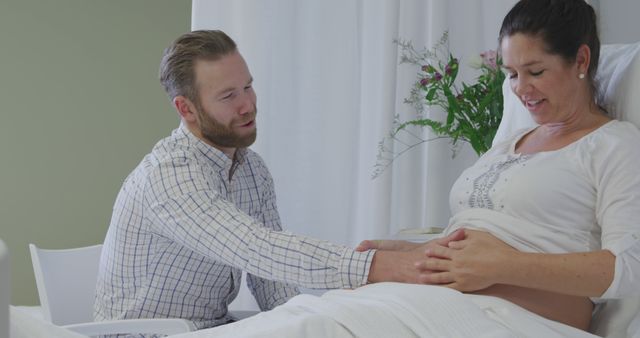 Expectant Couple in Hospital Room Sharing Tender Moment During Pregnancy - Download Free Stock Images Pikwizard.com